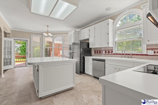 3401 Sussex Ct, Florence, SC 29501 - kitchen featuring black appliances, ornamental molding, a kitchen island, tasteful backsplash, and light countertops