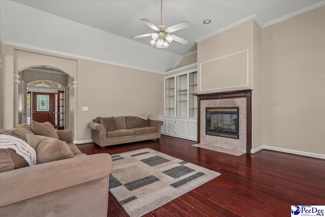 3401 Sussex Ct, Florence, SC 29501 - living area featuring dark wood finished floors, arched walkways, a tile fireplace, a ceiling fan, and crown molding
