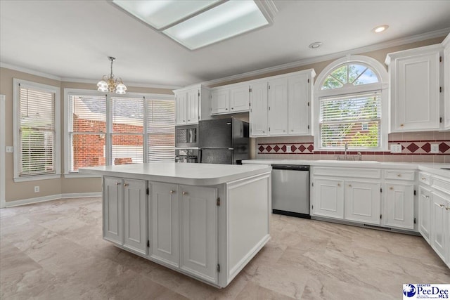 3401 Sussex Ct, Florence, SC 29501 - kitchen with appliances with stainless steel finishes, crown molding, white cabinets, a kitchen island, and a chandelier