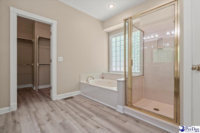 3401 Sussex Ct, Florence, SC 29501 - full bath with a stall shower, a garden tub, wood finished floors, and a spacious closet