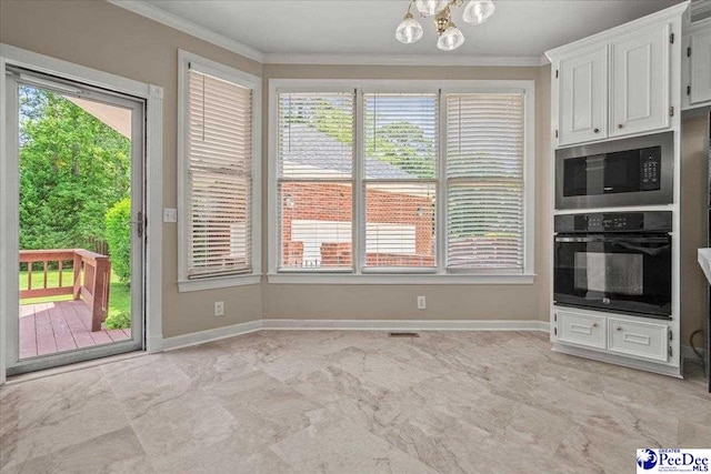 3401 Sussex Ct, Florence, SC 29501 - kitchen featuring oven, ornamental molding, stainless steel microwave, a chandelier, and plenty of natural light
