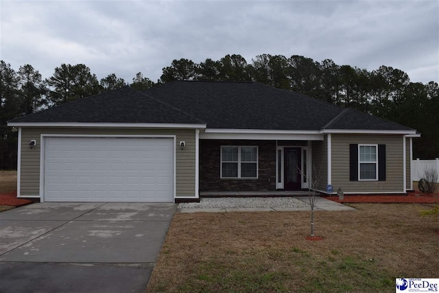 single story home with a garage and a front yard