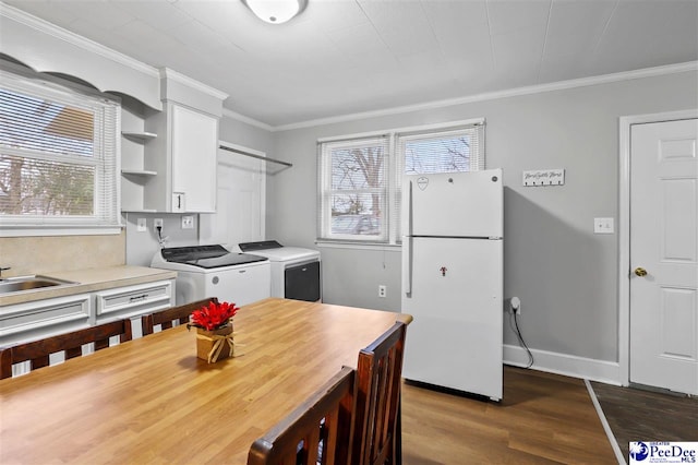 kitchen featuring sink, independent washer and dryer, white refrigerator, white cabinets, and dark hardwood / wood-style flooring