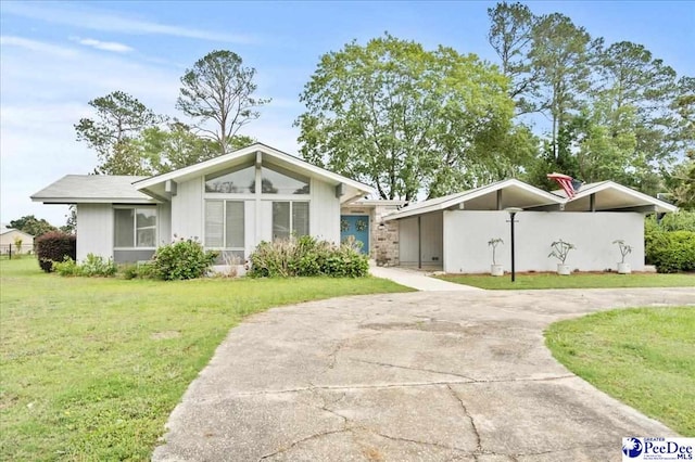 1040 Left Bank Dr, Florence, SC 29501 - mid-century modern home featuring concrete driveway and a carport