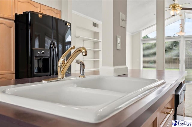 1040 Left Bank Dr, Florence, SC 29501 - detailed view of black fridge with ice dispenser, a sink, a ceiling fan, and light countertops