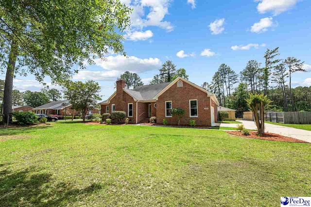 4128 W Pelican Ln, Florence, SC 29501 - ranch-style home with a chimney, brick siding, and driveway