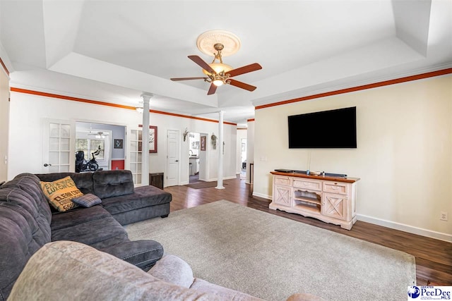4128 W Pelican Ln, Florence, SC 29501 - living room with a tray ceiling, ceiling fan, wood finished floors, and ornate columns