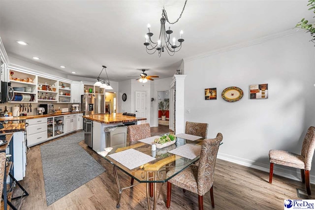 4128 W Pelican Ln, Florence, SC 29501 - dining area with a ceiling fan, ornamental molding, a chandelier, dark wood-style flooring, and baseboards