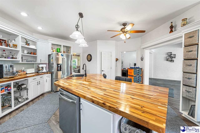 4128 W Pelican Ln, Florence, SC 29501 - kitchen with butcher block counters, stainless steel appliances, a sink, a ceiling fan, and open shelves
