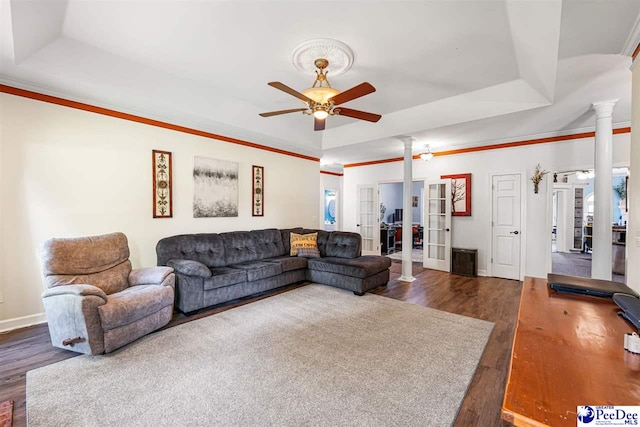 4128 W Pelican Ln, Florence, SC 29501 - living room with wood finished floors, a ceiling fan, ornate columns, baseboards, and a raised ceiling