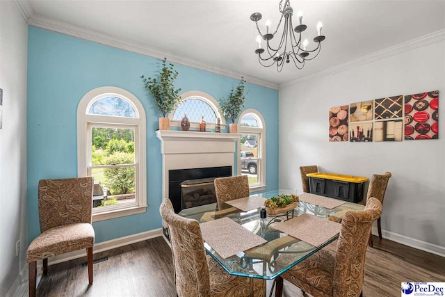 4128 W Pelican Ln, Florence, SC 29501 - dining space with wood finished floors, a chandelier, plenty of natural light, baseboards, and crown molding