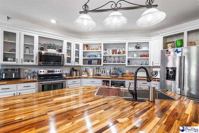 4128 W Pelican Ln, Florence, SC 29501 - kitchen featuring wooden counters, stainless steel appliances, open shelves, white cabinetry, and backsplash