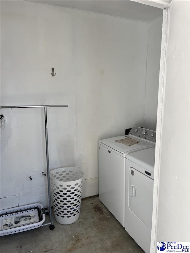 clothes washing area featuring laundry area and washer and clothes dryer