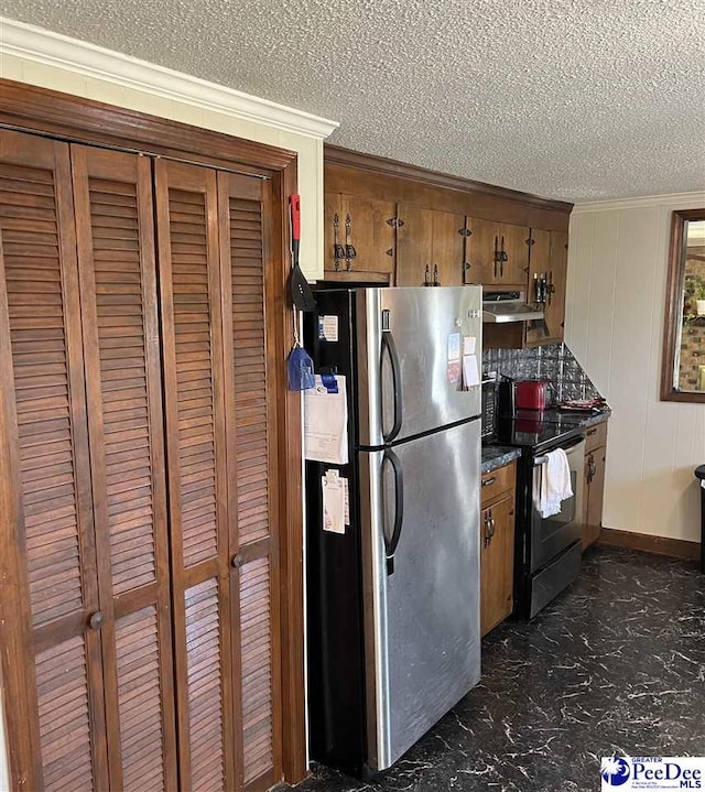 kitchen featuring electric range oven, brown cabinets, freestanding refrigerator, marble finish floor, and under cabinet range hood