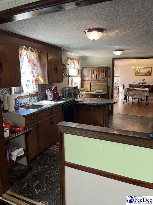 kitchen with black dishwasher, a textured ceiling, dark countertops, and a sink