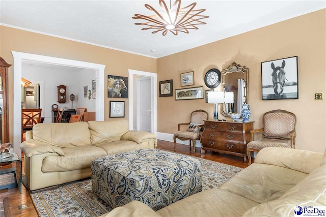 living room featuring crown molding, wood-type flooring, and an inviting chandelier