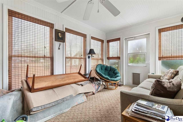 carpeted bedroom featuring crown molding and ceiling fan