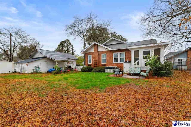 rear view of house featuring a yard