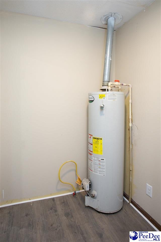 utility room featuring water heater