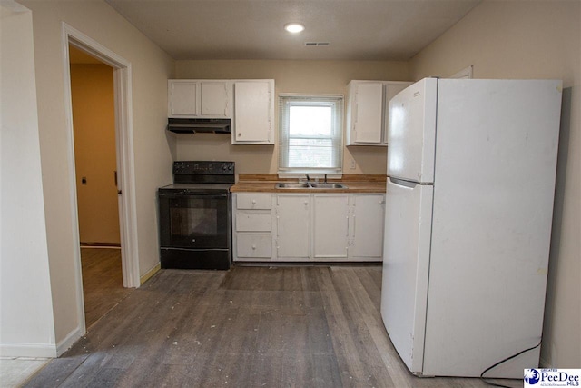 kitchen with electric range, freestanding refrigerator, white cabinets, a sink, and under cabinet range hood