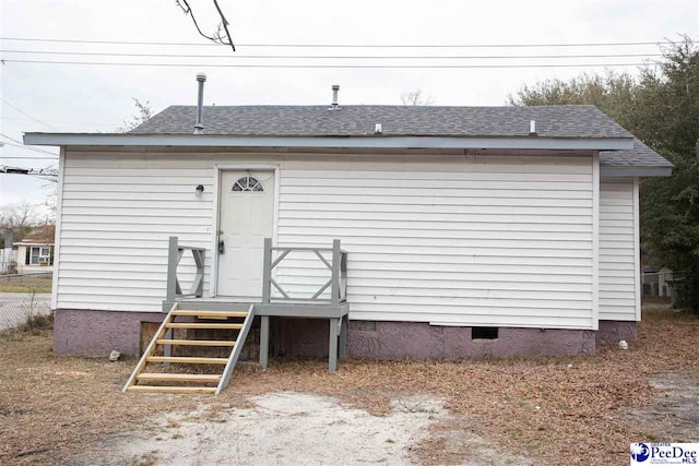 exterior space featuring roof with shingles and crawl space