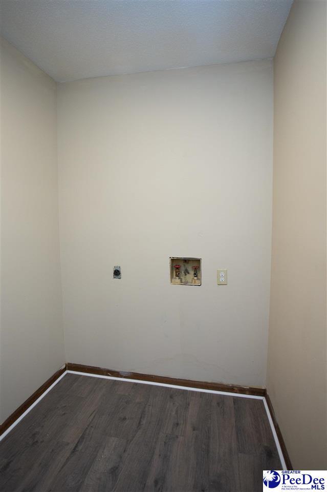 laundry room with laundry area, washer hookup, wood finished floors, and baseboards