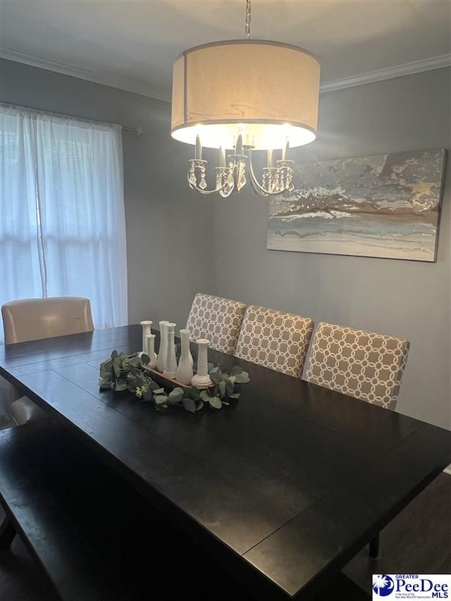 dining area with ornamental molding and a notable chandelier