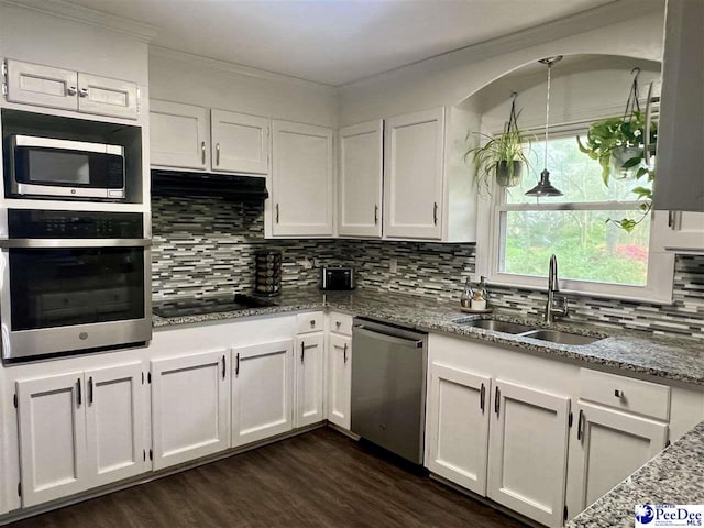 kitchen featuring appliances with stainless steel finishes, a sink, and white cabinetry