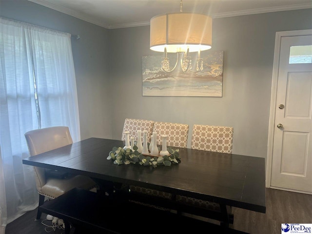 dining space with crown molding and wood finished floors