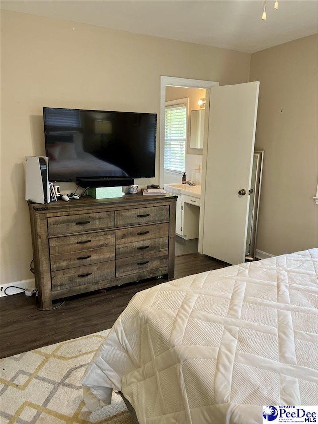 bedroom featuring dark wood finished floors