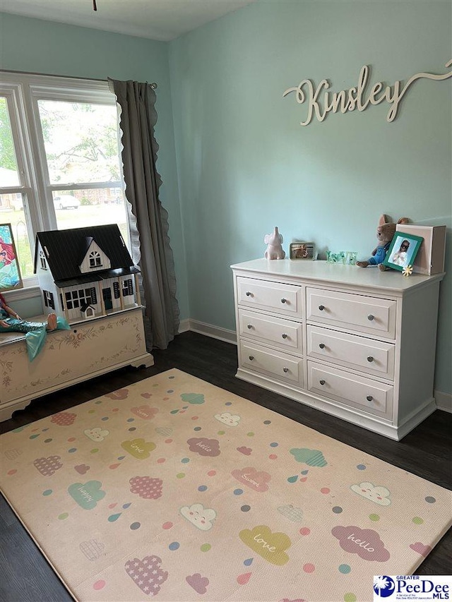 bedroom featuring dark wood-type flooring and baseboards