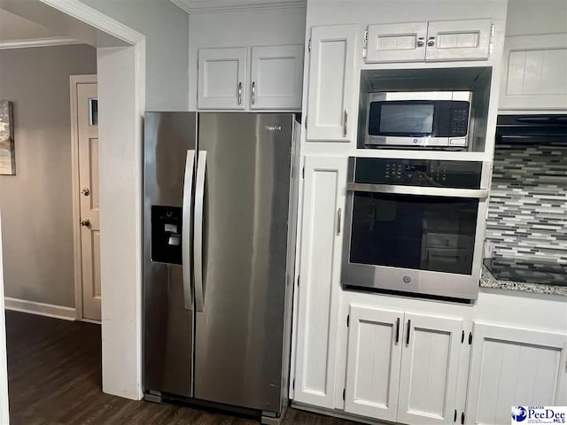 kitchen featuring tasteful backsplash, crown molding, white cabinets, dark wood finished floors, and stainless steel appliances