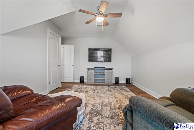 living area featuring visible vents, ceiling fan, baseboards, lofted ceiling, and wood finished floors