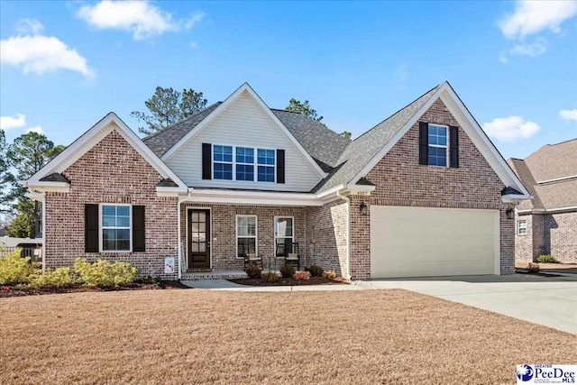 view of front facade with brick siding, concrete driveway, a garage, and a front yard