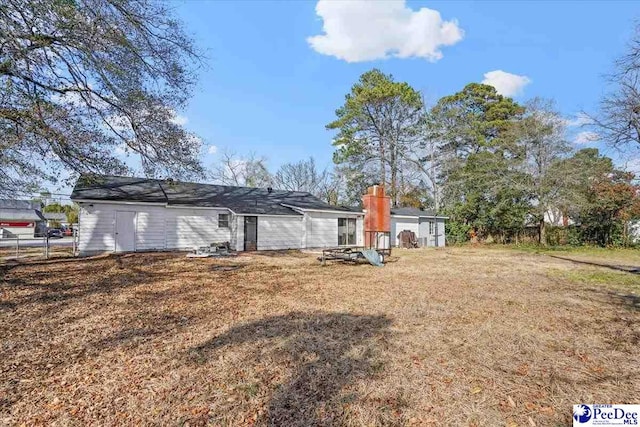 rear view of house with a lawn