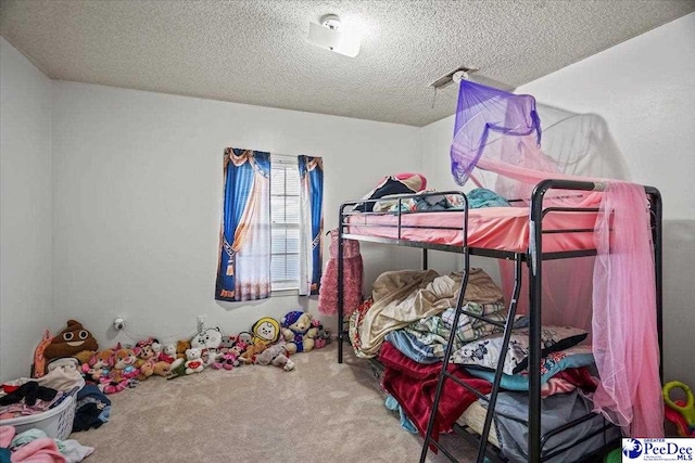 bedroom with carpet flooring and a textured ceiling