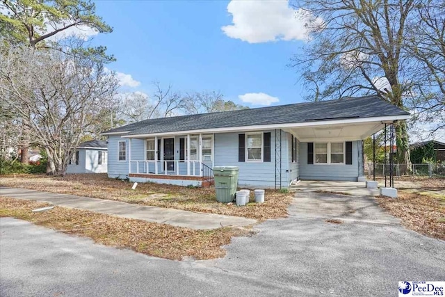 single story home with a carport and a porch