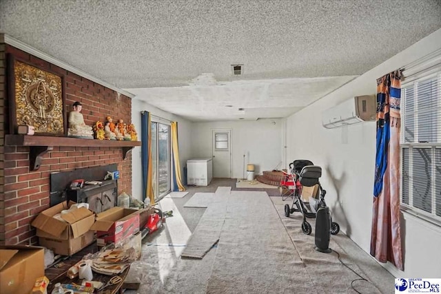 miscellaneous room featuring light colored carpet, a fireplace, a wall unit AC, and a textured ceiling