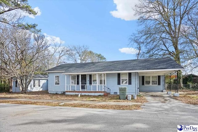 view of front of home with a carport and covered porch