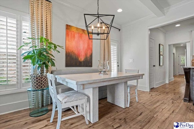 dining area featuring baseboards, recessed lighting, a notable chandelier, wood finished floors, and ornamental molding