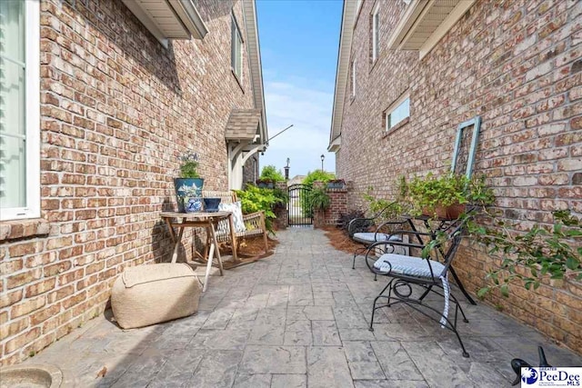 view of patio featuring a gate