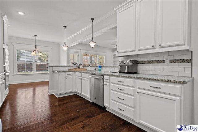 kitchen featuring crown molding, backsplash, appliances with stainless steel finishes, a peninsula, and white cabinets