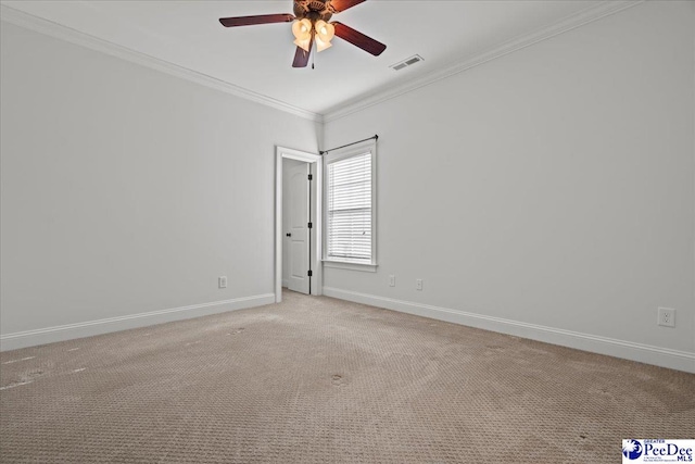empty room with visible vents, baseboards, ornamental molding, ceiling fan, and light carpet