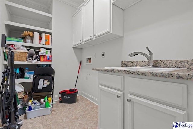 laundry area featuring hookup for a washing machine, baseboards, a sink, hookup for an electric dryer, and cabinet space