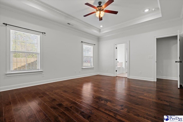 unfurnished room with visible vents, baseboards, a ceiling fan, a raised ceiling, and hardwood / wood-style floors