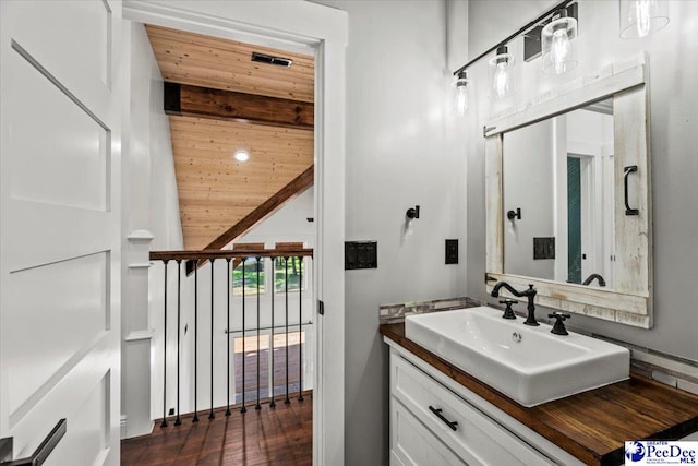 bathroom featuring vanity, wooden ceiling, and beamed ceiling