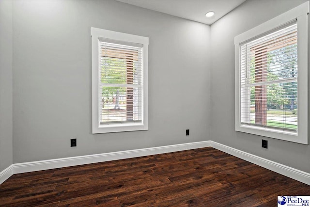 spare room featuring dark hardwood / wood-style floors