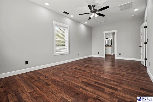 spare room with dark hardwood / wood-style flooring and ceiling fan