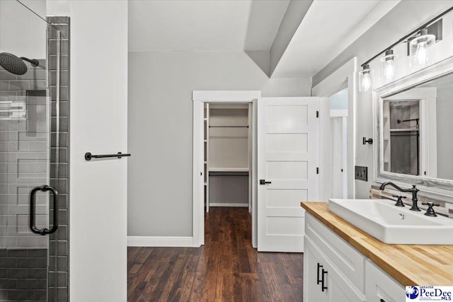 bathroom with vanity, an enclosed shower, and hardwood / wood-style flooring