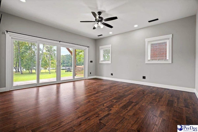 spare room with dark wood-type flooring and ceiling fan